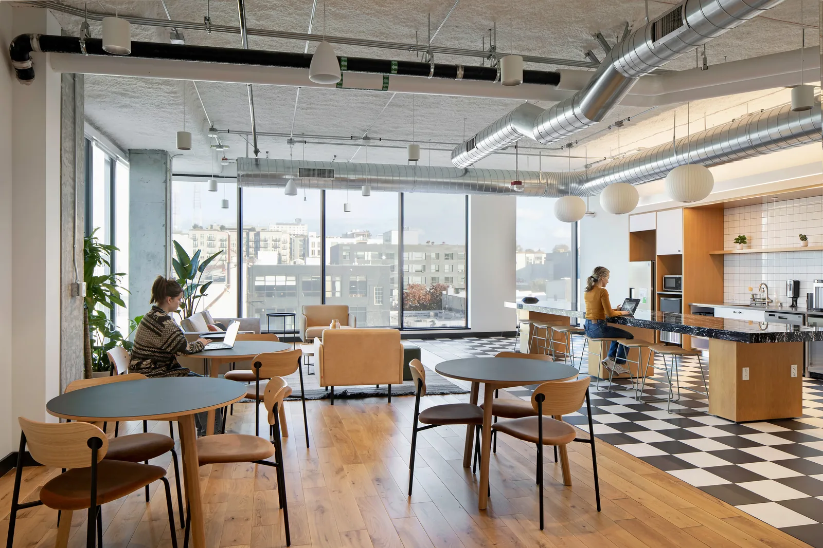Café tables and the kitchen at CENTRL Capitol Hill.