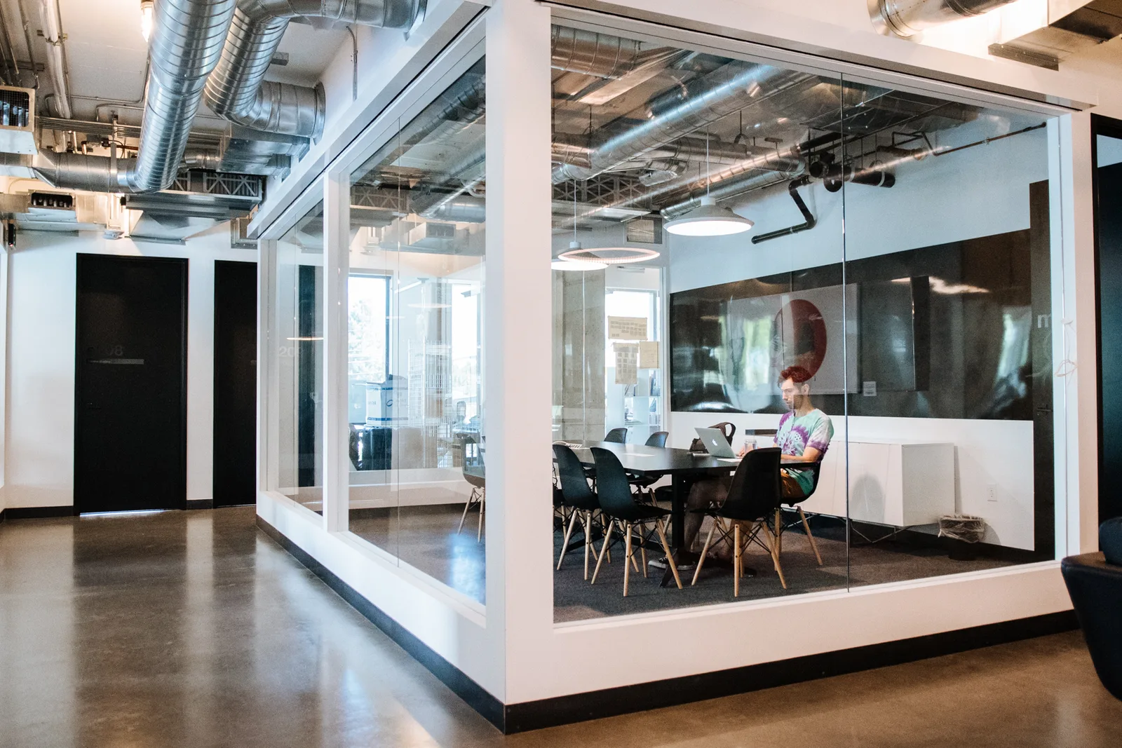 A glass-walled meeting room at CENTRL Eastside.
