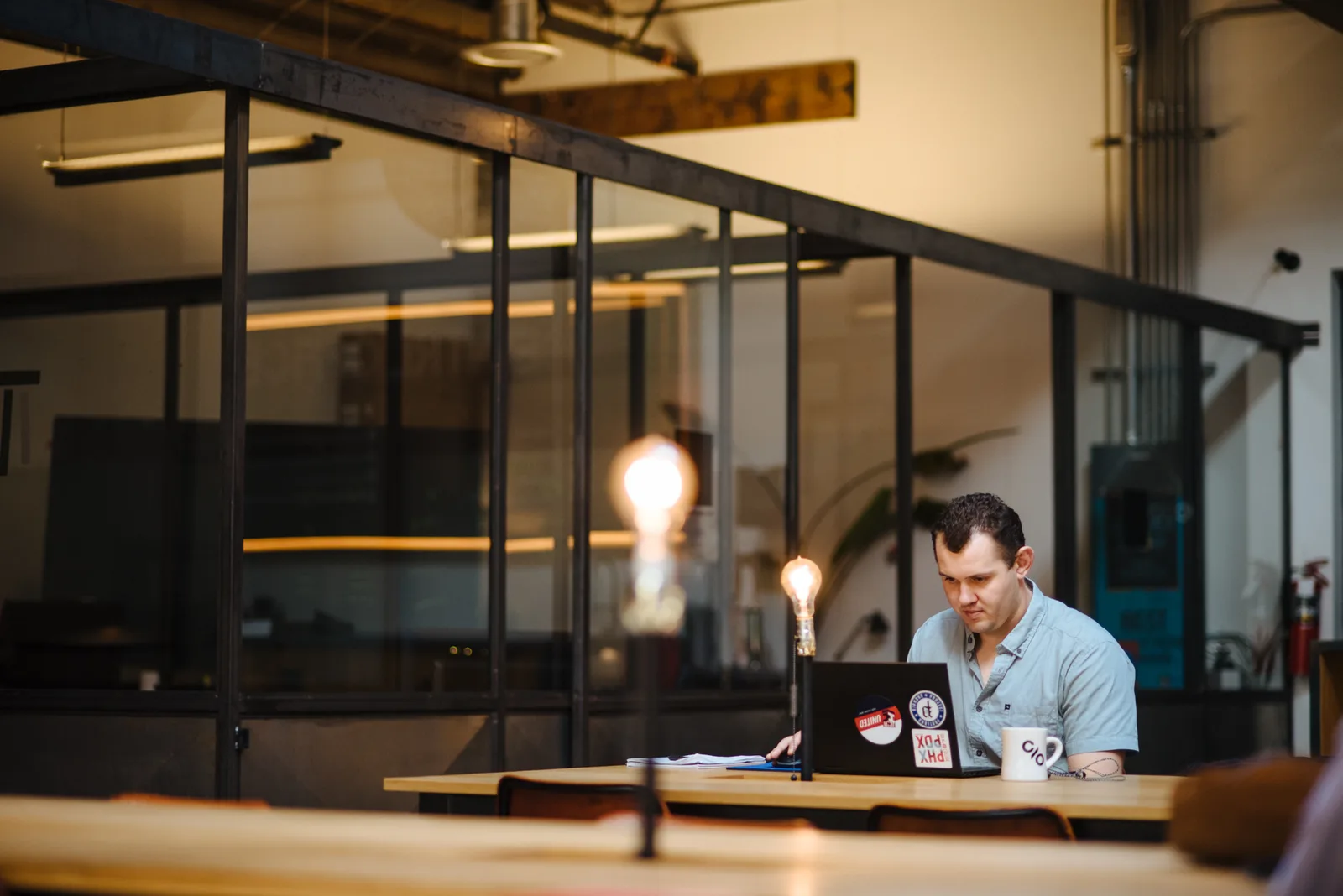 Shared desks under the mezzanine at CENTRL Pearl District.