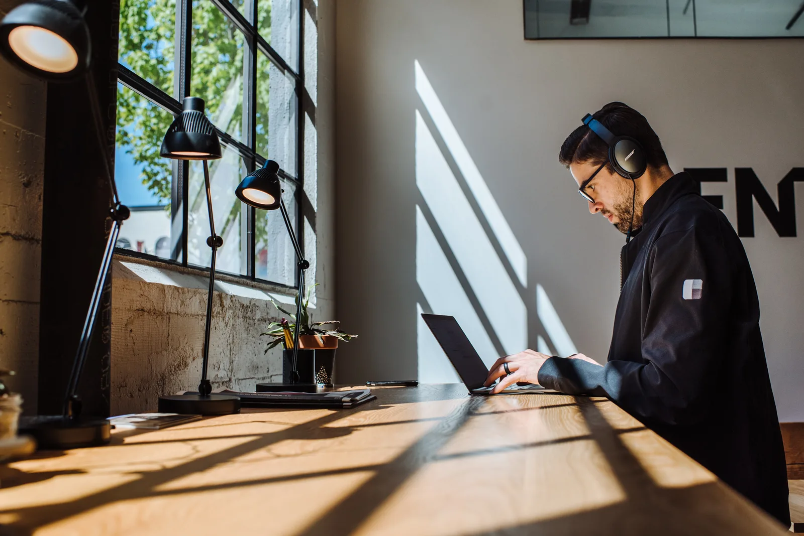 A member working at a window desk at CENTRL Pearl District.
