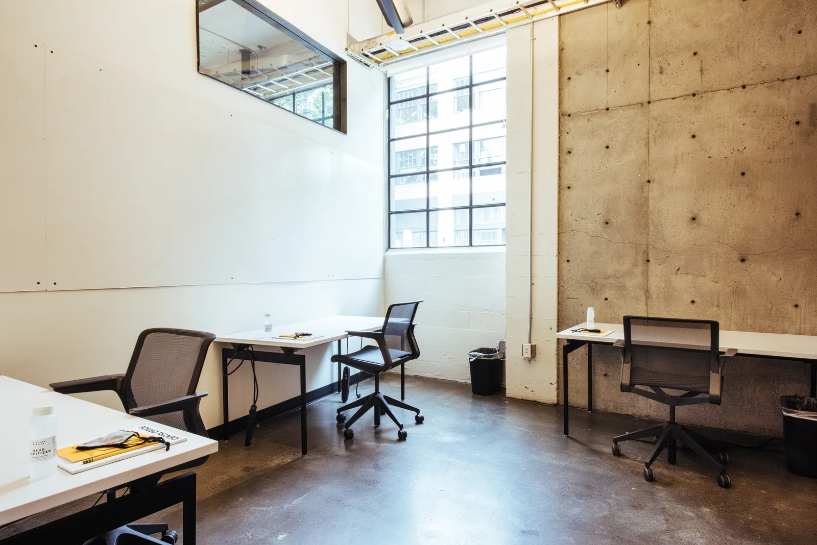 A private office with concrete walls at CENTRL Pearl